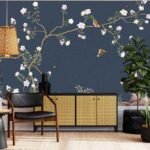 Dark blue floral wallpaper featuring pink and white blossoms, green branches and colourful birds in a modern interior