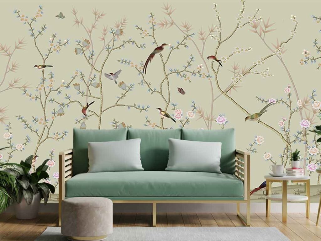 Bird and branch wallpaper featuring delicate flowers, pastel foliage and colourful birds on a soft beige background behind a modern living room