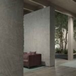 Textured grey abstract wallpaper with delicate etched lines creating a minimalist luxury feature wall in a modern interior