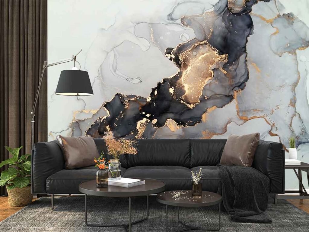 Black gold marble wallpaper featuring charcoal abstract stone formations, flowing golden veins and soft white grey textures behind a modern sofa