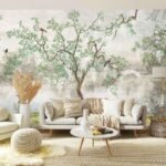 Nature tree wallpaper featuring green branches, small birds and a soft misty landscape behind a neutral living room